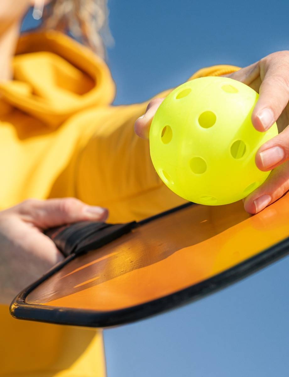 Pickleball,Paddle,And,Yellow,Ball,Close,Up,,Woman,Playing,Pickleball Girl Holding Pickleball paddle for Private Event